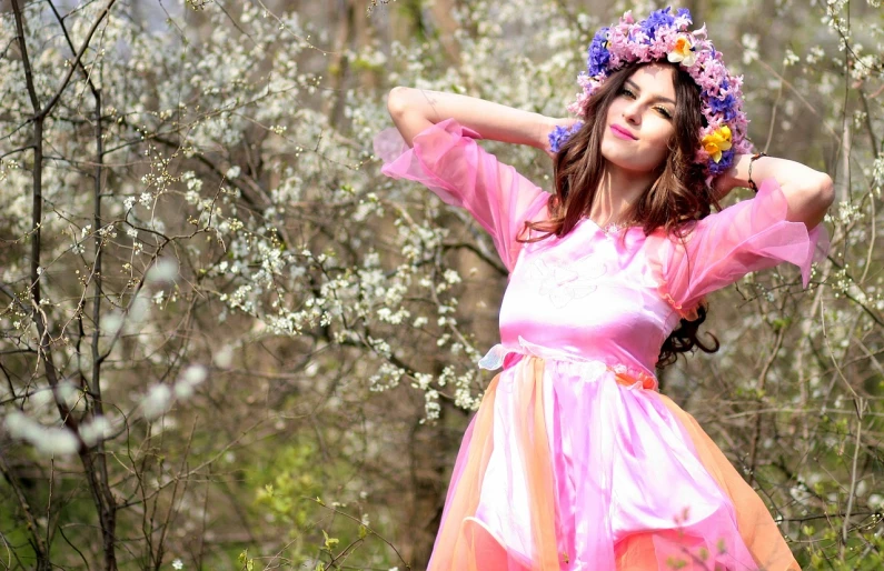 a woman in a pink dress posing for a picture, a portrait, inspired by Konstantin Somov, flickr, romanticism, vivid flower crown, brunette elf with fairy wings, spring colors, neon colored dress