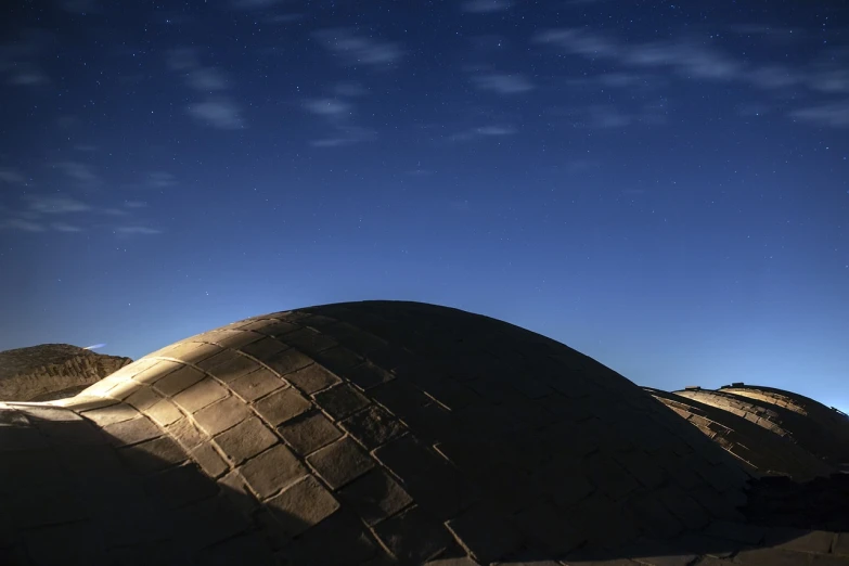 a man riding a skateboard up the side of a ramp, a detailed matte painting, by Youssef Howayek, flickr, in an igloo, night under the starry sky, timelapse, built in the egyptian desert