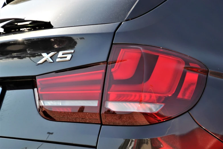a close up of the tail lights of a car, a picture, by Werner Gutzeit, pexels, photorealism, bmw, hooded, hyperrealistic image of x, with backlight
