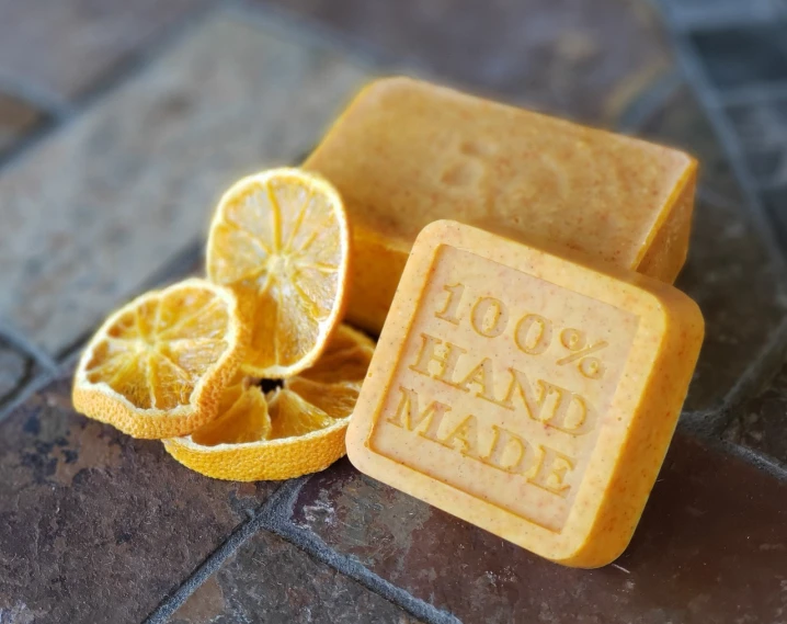 a soap bar sitting on top of an orange slice, by Alexander Brook, hand made, over the shoulder view, closeup - view, award winning