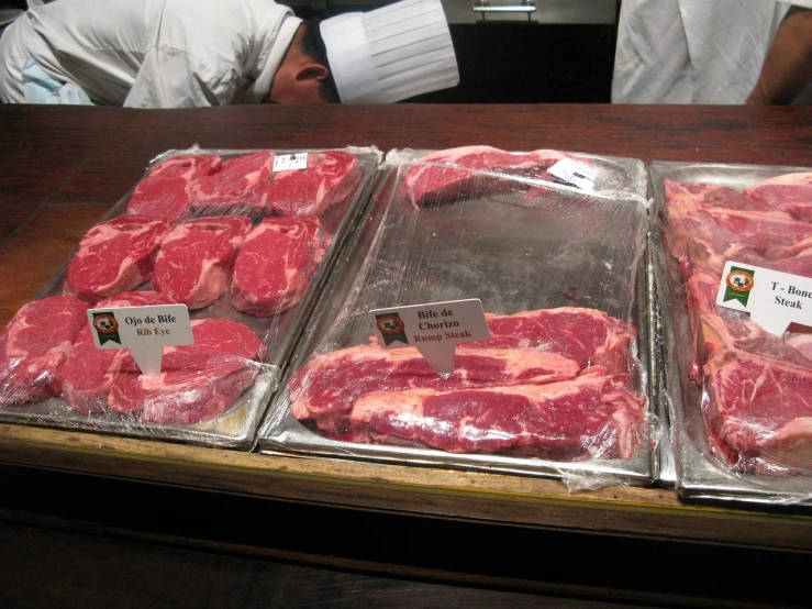 a couple of trays of meat sitting on top of a table, by Samuel Scott, flickr, manhattan, cut-away, at the counter, grain”