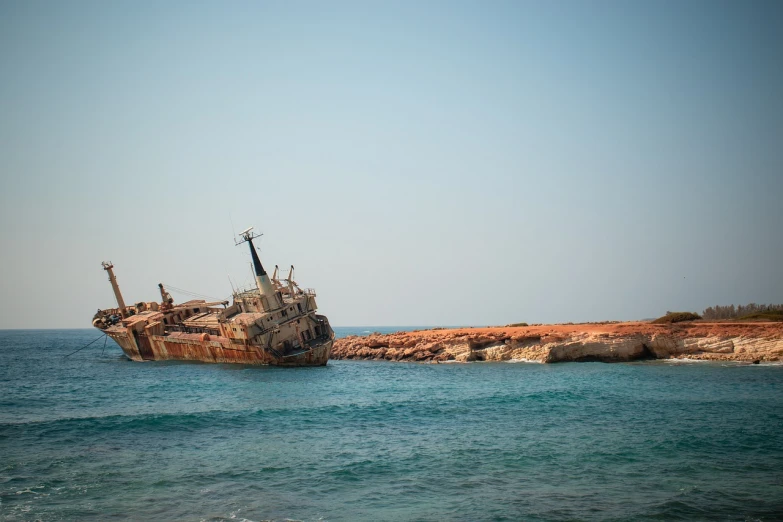 a boat sitting on top of a body of water, by Richard Carline, cyprus, rust, stern like athena, gooey