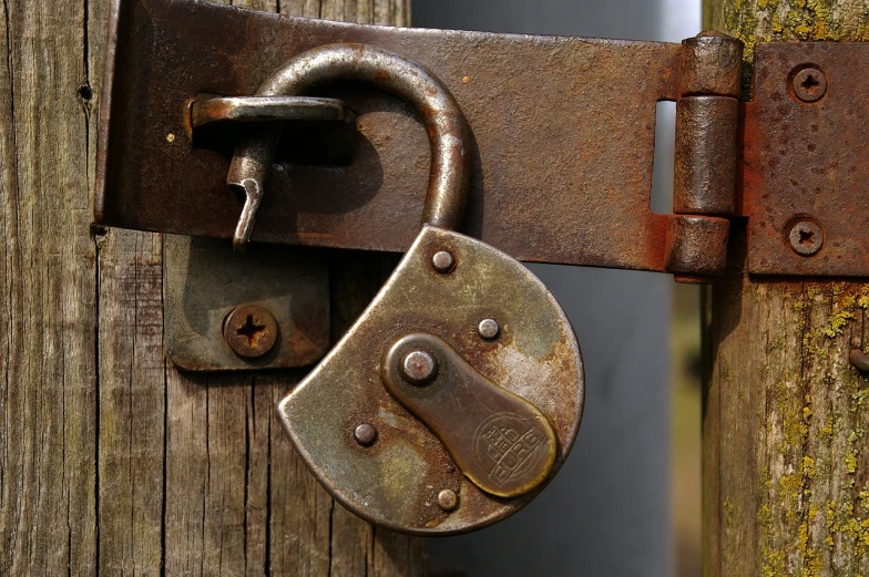 a close up of a padlock on a wooden pole, by Walenty Wańkowicz, flickr, renaissance, open door, highdetailed, dingy, (rust)