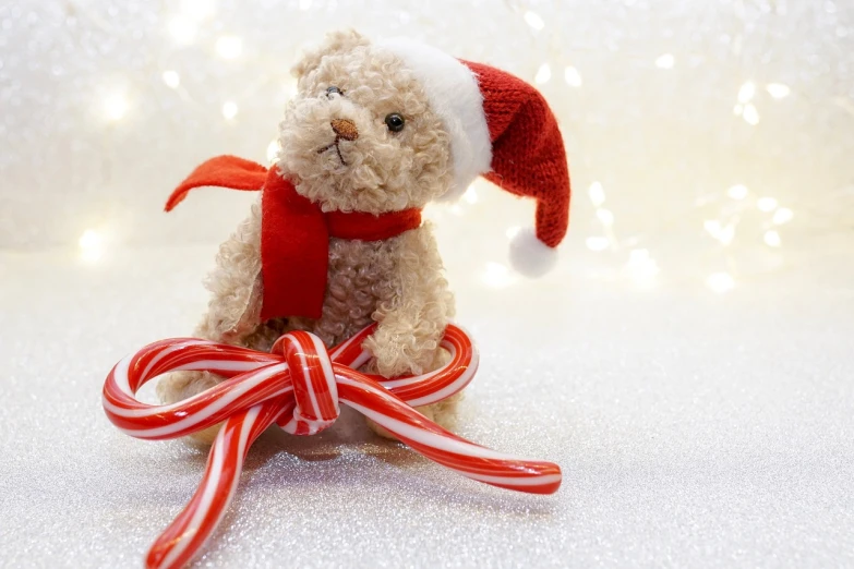 a teddy bear sitting on top of a candy cane, a picture, inspired by Ernest William Christmas, pexels, istockphoto, cane, toy photo, commissioned