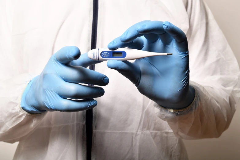 a person in a white shirt and blue gloves holding a thermometer, highly detailed product photo, 2 0 2 2 photo, fertility, detailed zoom photo