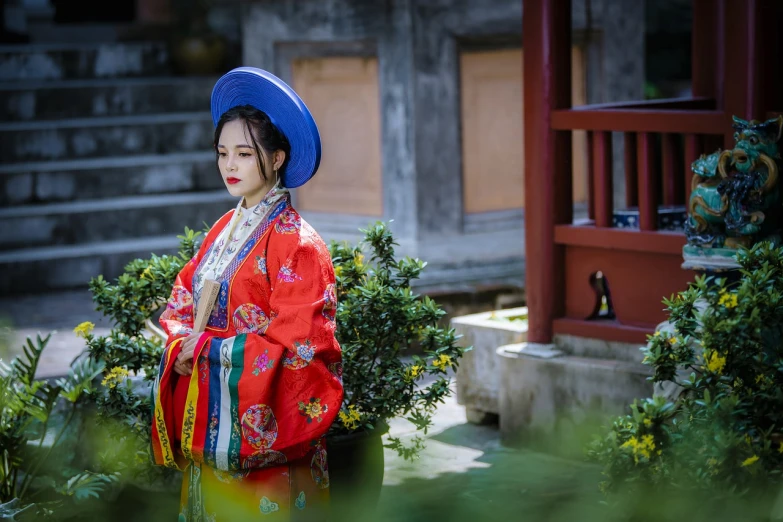 a woman wearing a red dress and a blue hat, inspired by Gu An, trending on cg society, cloisonnism, high quality theatre costume, ((wearing aristocrat robe)), 💣 💥, captured on canon eos r 6