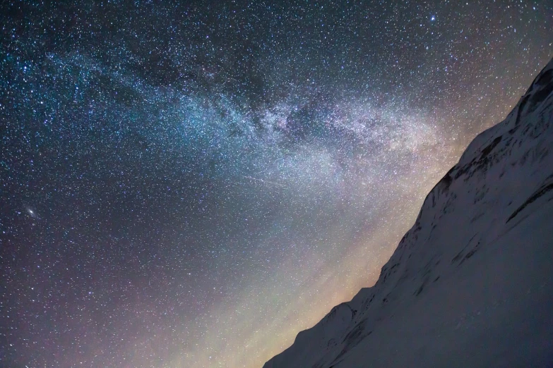 a person standing on top of a snow covered slope, pexels, milky way nebula, mt elbrus at night, 1 2 9 7, highly detaile