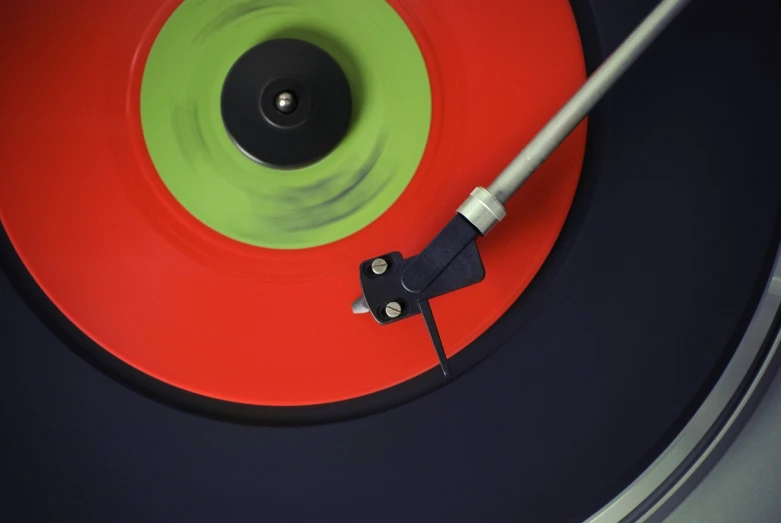 a close up of a record on a turntable, by Jan Rustem, pop art, green bright red, split - complementary - colors, 7 0 s photo, dart board