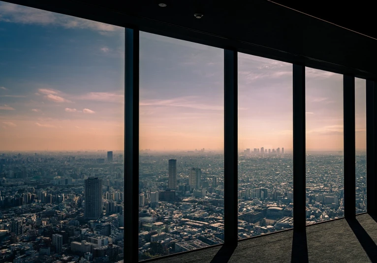 a view of a city from the top of a building, a picture, unsplash contest winner, modernism, golden hour in tokyo, inside a tall vetical room, panoramic widescreen view, silhouetted