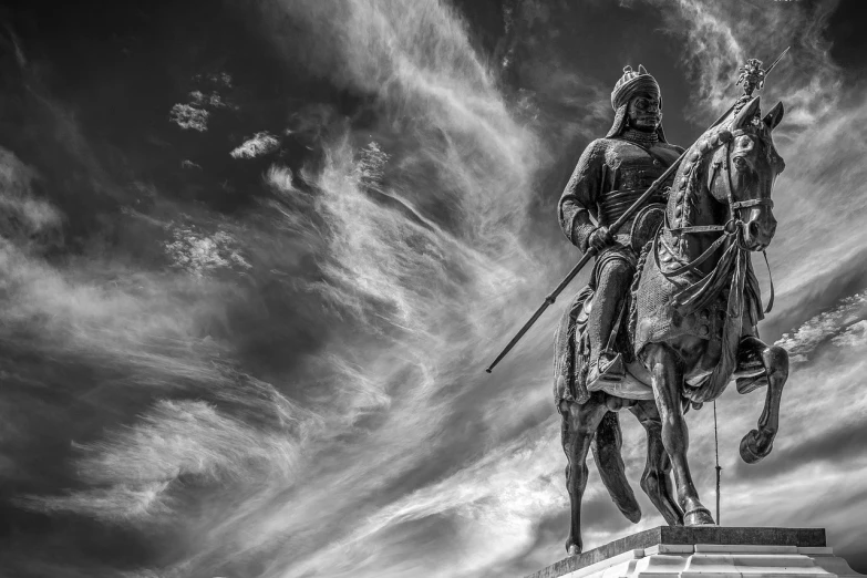 a black and white photo of a statue of a man on a horse, a statue, by Felipe Seade, fine art, sword pointed at sky, photo of genghis khan, 4k wallpaper, ivan aivazovski