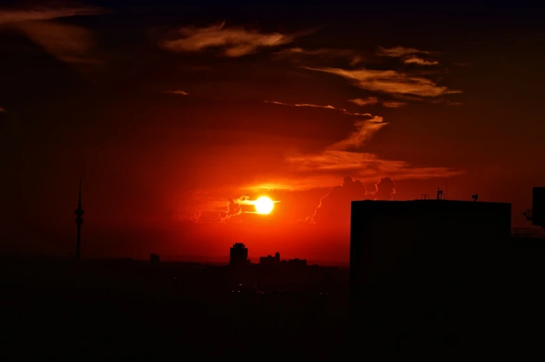 the sun is setting over the city skyline, a photo, red cloud light, very beautiful photo, late night melancholic photo