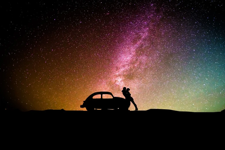 a man standing on top of a hill next to a car, a picture, romanticism, the sky has the milky way, the kiss, nostalgic and euphoric, cosmic and colorful