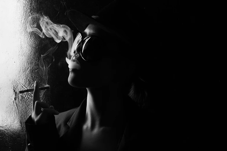 a black and white photo of a woman smoking a cigarette, inspired by Helmut Newton, fine art, wearing sunglasses and a hat, shot at dark with studio lights, detective, in style of kyrill kotashev