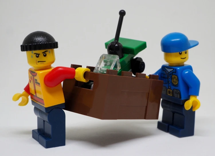 a couple of lego men standing next to each other, a picture, pixabay, small boat, automated defence platform, police, mine cart