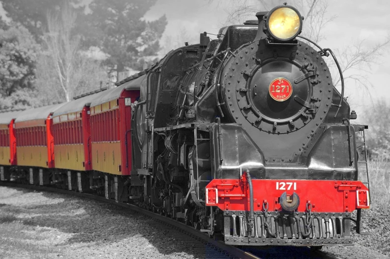 a black and red train traveling down train tracks, a colorized photo, trending on pixabay, grayscale phtoto with red dress, golden engines, cp2077, portrait n - 9