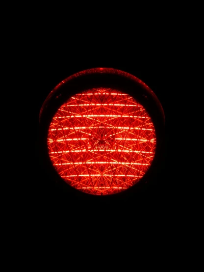 a close up of a traffic light in the dark, by Jon Coffelt, flickr, flower of life, very red colors, bottom - view, round about to start