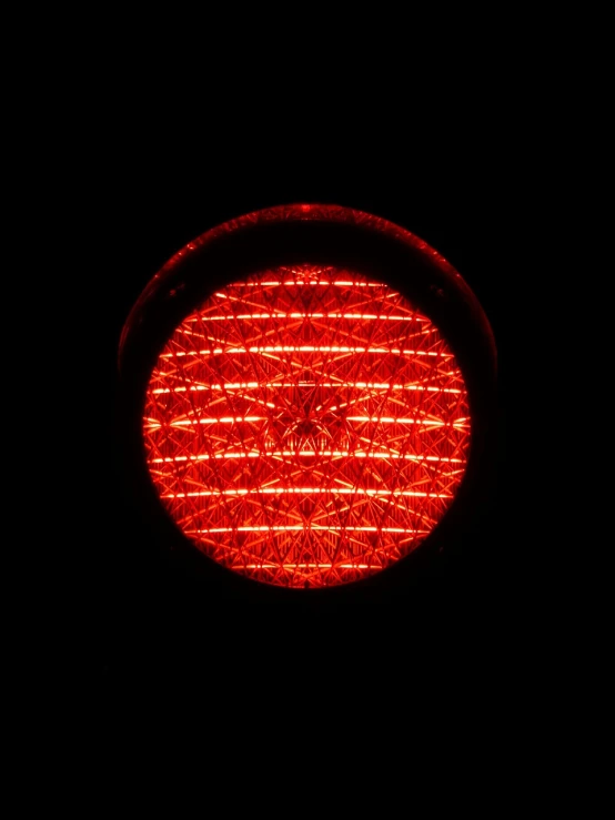 a close up of a traffic light in the dark, by Jon Coffelt, flickr, flower of life, very red colors, bottom - view, round about to start