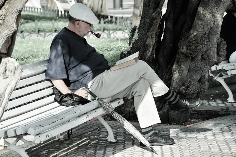 a man sitting on a bench with a pipe in his mouth, a photo, pixabay contest winner, figuration libre, reading under a tree, turkey, stock photo, high res photo