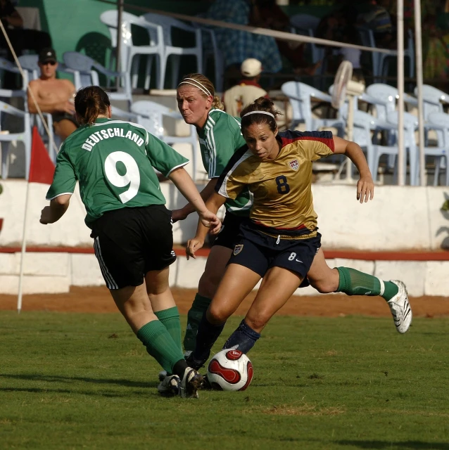 a group of young women playing a game of soccer, flickr, wearing elaborate green and gold, soccer player, fernando guerra, mid - action