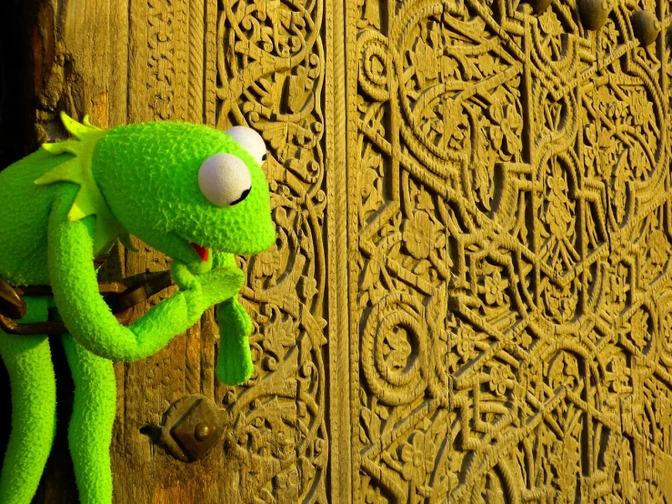a close up of a stuffed animal on a door, a picture, inspired by Károly Brocky, celtic, kermit, 3d cg, aardman animation