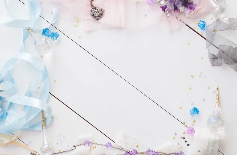 a white table topped with lots of pink and blue decorations, a picture, aestheticism, treasure background, universal background, crystal particles, ribbons and flowers