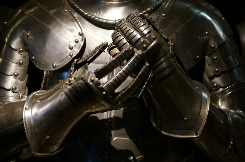 a close up of a person wearing a suit of armor, by Simon de Vlieger, flickr, renaissance, black hands with black claws, like in museum, chunky gauntlets, with mechanical arms that fix it