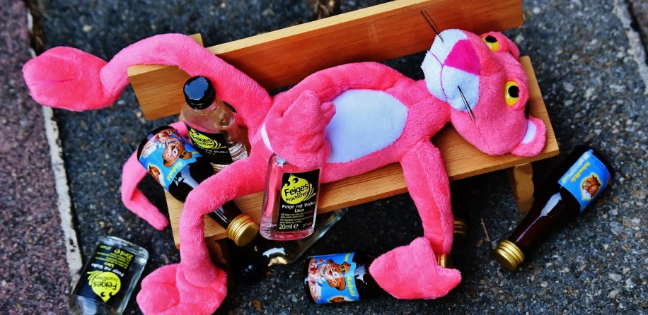 a pink stuffed animal sitting on top of a wooden bench, a picture, by Tom Carapic, booze, ren and stimpy style, knockout punch, uncropped