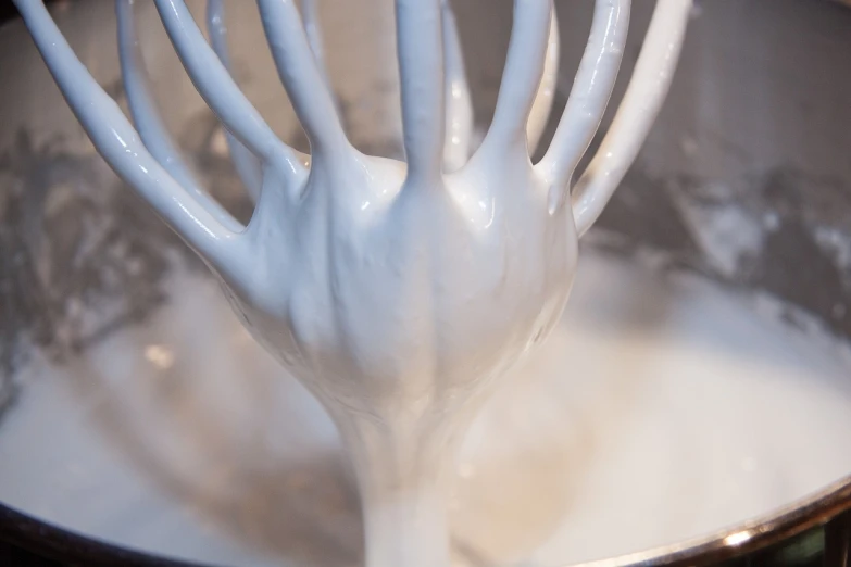 a close up of a whisk in a bowl of milk, flickr, process art, big hands, silicone skin, closeup 4k, bright white porcelain