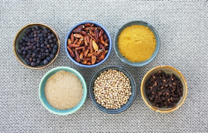 a number of bowls with different types of food in them, a portrait, by Juan O'Gorman, pexels, spices, mustard, indigo, felt