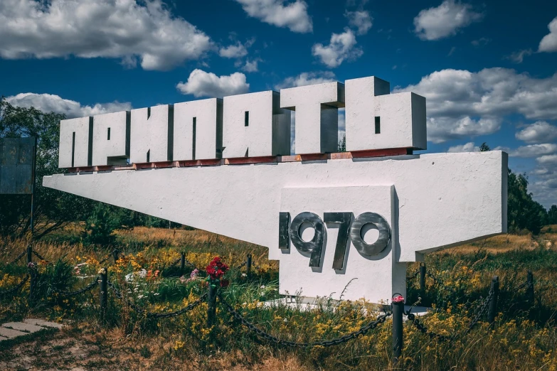 a large white sign sitting in the middle of a field, by Anato Finnstark, unsplash, graffiti, 1 9 6 0 s soviet poster, pharaoh, marquee, azamat khairov