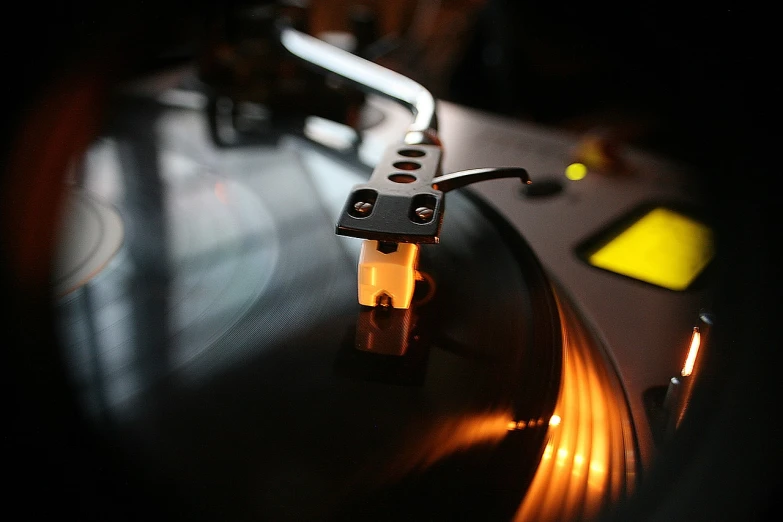 a close up of a record player's turntable, by Adam Chmielowski, flickr, at dusk!, everyone having fun, chris moore”, dramatic lighting”