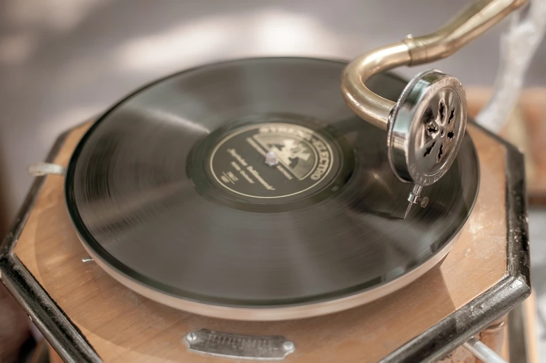 a record player sitting on top of a wooden table, by Hariton Pushwagner, shutterstock, bauhaus, sousaphone, detailed zoom photo, packshot, engraved