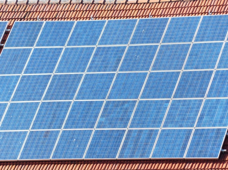 a close up of a solar panel on a roof, a stock photo, by Jakob Gauermann, shutterstock, bauhaus, pattern, view from slightly above, elevation, platform