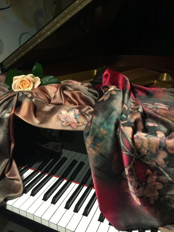 a scarf sitting on top of a piano keyboard, a still life, inspired by Kawai Gyokudō, romanticism, translucent roses ornate, silk colors, fancy drapery on furniture, orazio gentileschi style