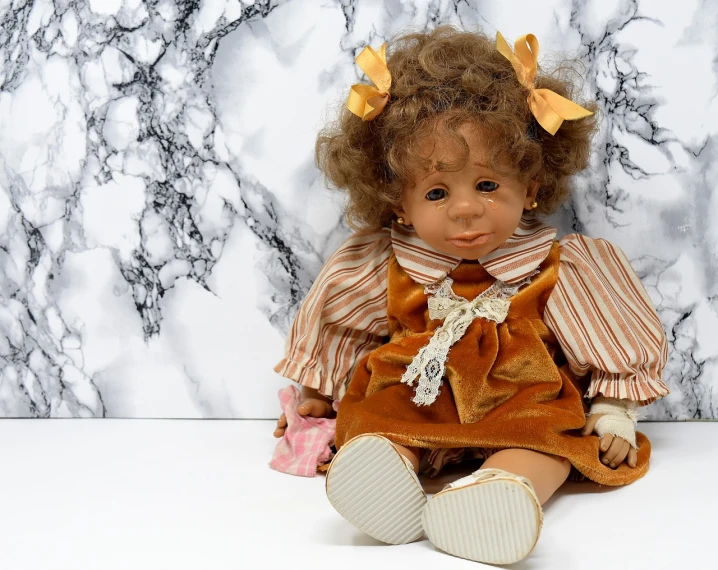 a close up of a doll on a table, inspired by Margaret Brundage, trending on pixabay, 🍂 cute, 1 9 9 4, caramel, toddler