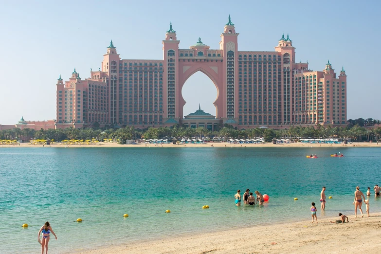 a group of people standing on top of a beach next to a body of water, by Richard Carline, shutterstock, a pool inside the giant palace, atlantis city, viewed from the harbor, gta : dubai