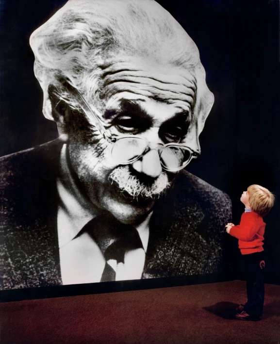 a little boy standing in front of a picture of an old man, inspired by Antanas Sutkus, interactive art, portrait of einstein, photo courtesy museum of art, big brain, mark twain