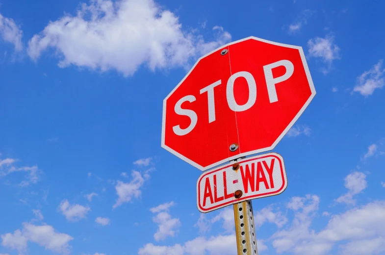 a red stop sign sitting on top of a metal pole, a picture, by Whitney Sherman, pixabay, stock photo, interrupting the big game, broadway, blue sky
