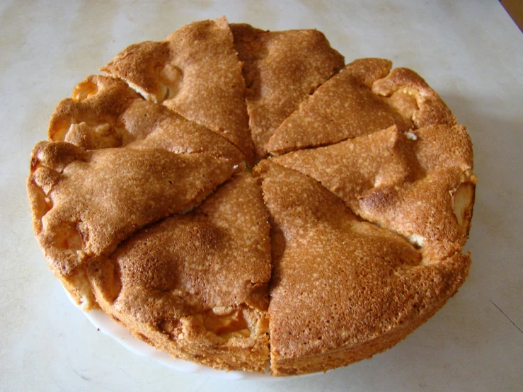 a pie sitting on top of a white plate, by Aleksander Kotsis, flickr, hurufiyya, apple pie, 1 5 th century, agrigento, view from bottom to top