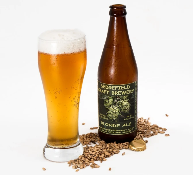a glass of beer next to a bottle of beer, inspired by HAP Grieshaber, high res photo, silvergill adept, blonde, hemp