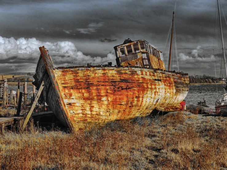 a rusted boat sitting on top of a dry grass covered field, by Edward Corbett, flickr, vibrant but dreary gold, colorised, bottom angle, owlship