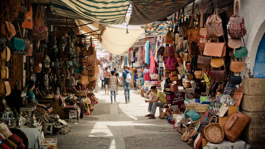 a street filled with lots of bags and purses, renaissance, inside an arabian market bazaar, on a sunny day, 🕹️ 😎 🔫 🤖 🚬, hippie