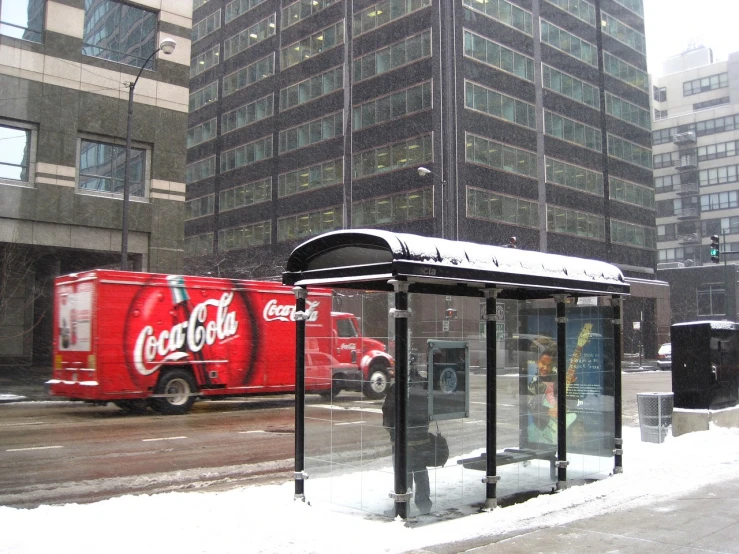 a bus stop with a coca cola truck in the background, by Jon Coffelt, flickr, snowstorm ::5, glass buildings, fully covered, subway