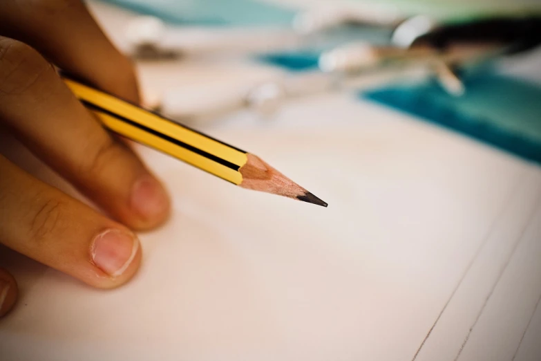 a person holding a pencil over a piece of paper, academic art, healthcare worker, professional closeup photo, detailed picture, surgical supplies