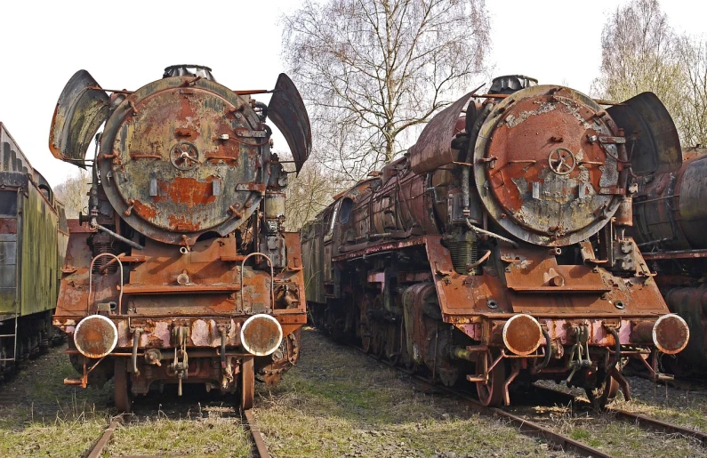 a couple of old trains sitting next to each other, by Werner Gutzeit, auto-destructive art, left right front back, vintage - w 1 0 2 4, huge battle, well preserved