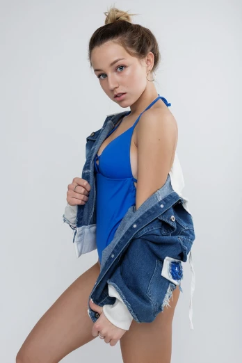 a woman in a blue tank top and denim jacket, tumblr, photorealism, young swimsuit model, of a schoolgirl posing, product introduction photo, cyborg fashion model