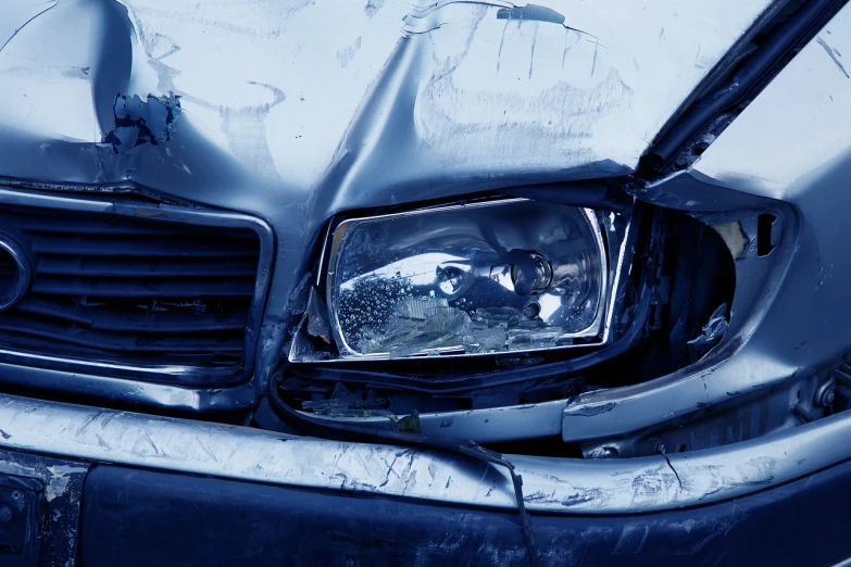 a close up of a damaged headlight on a car, a picture, pexels, upturned nose, blue headlights, crashcart, 3 dimensional