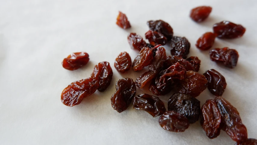 a pile of dried raisin raisin raisin raisin raisin raisin raisin raisin raisin raisin raisin rai rai, inspired by Masamitsu Ōta, round about to start, dlsr photo, smooth tiny details, on a gray background