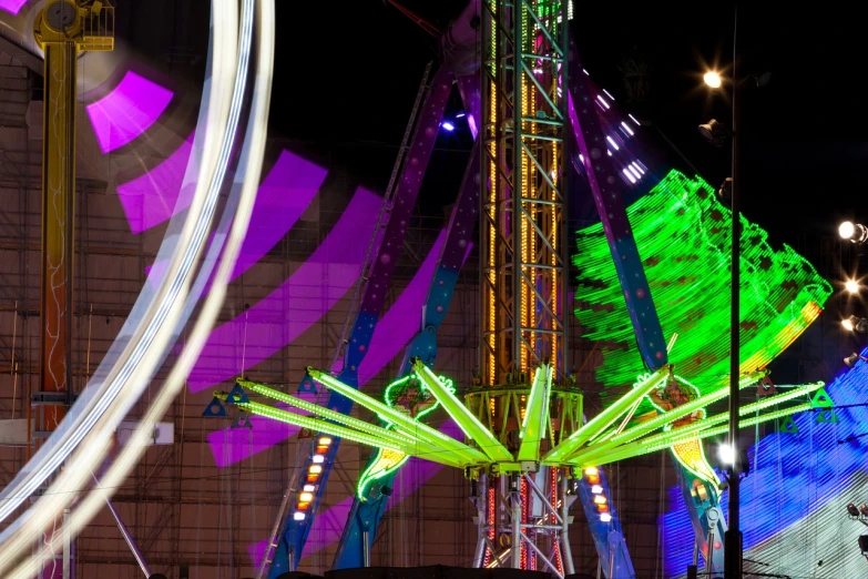 a carnival ride at night with colorful lights, kinetic art, lime and violet, high res photo, swings, with fluo colored details