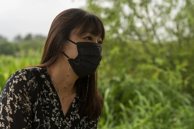 a close up of a person wearing a face mask, shin hanga, countryside in japan, profile portrait of a woman, taiwan, polluted